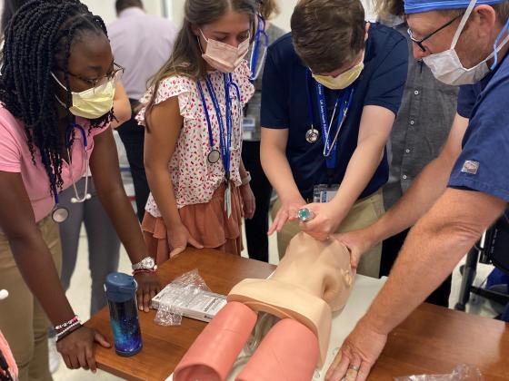 Students participating in SEP learning how to intubate on a manikin head.
